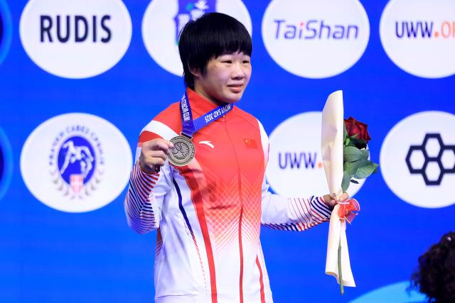 (251024) -- NOVI SAD, Oct. 24, 2025 (Xinhua) -- Gold medalist China's Liang Jinyue pose photos during the awarding ceremony for women's 50 kg category at the U23 Wrestling World Championships in Novi Sad, Serbia on Oct. 23, 2025. (Photo by Predrag Milosavljevic/Xinhua)