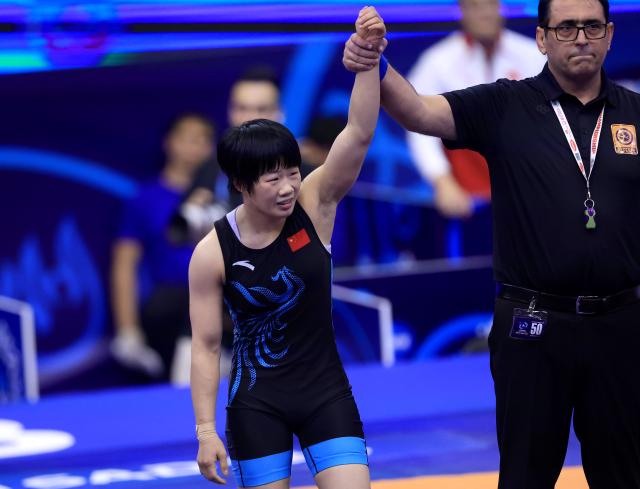 (251024) -- NOVI SAD, Oct. 24, 2025 (Xinhua) -- China's Liang Jinyue celebrates victory against Audrey Rae Jimenez of the United States after their final match of the women's 50 kg category at the U23 Wrestling World Championships in Novi Sad, Serbia on Oct. 23, 2025. (Photo by Predrag Milosavljevic/Xinhua)