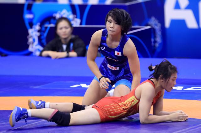 (251024) -- NOVI SAD, Oct. 24, 2025 (Xinhua) -- Japan's Akari Fujinami (up) and China's Tang Yifan compete during their 1/8 final match of the women's 57 kg category at the U23 Wrestling World Championships in Novi Sad, Serbia on Oct. 23, 2025. (Photo by Predrag Milosavljevic/Xinhua)