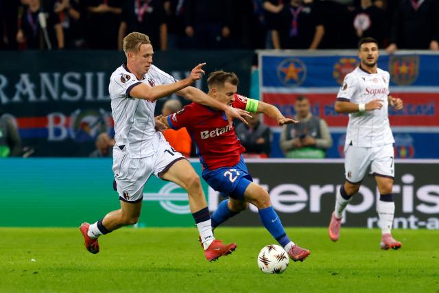 (251024) -- BUCHAREST, Oct. 24, 2025 (Xinhua) -- FCSB's Darius Olaru (R) vies with Bologna's Torbjorn Heggem during their UEFA Europa League football match in Bucharest, Romania, Oct. 23, 2025. (Photo by Cristian Cristel/Xinhua)