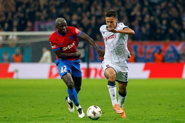 (251024) -- BUCHAREST, Oct. 24, 2025 (Xinhua) -- FCSB's Baba Alhassan (L) vies with Bologna's Nikola Moro during their UEFA Europa League football match in Bucharest, Romania, Oct. 23, 2025. (Photo by Cristian Cristel/Xinhua)