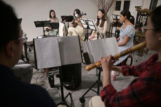 (251024) -- SINGAPORE, Oct. 24, 2025 (Xinhua) -- Members of a music society named Siong Leng learn Nanyin in Singapore on Jan. 13, 2025. Nanyin, which originated from southeast China's Fujian Province, is known as the "living fossil" of ancient Chinese music and literally means music in the south. It is a traditional opera in Fujian dialect.
In 2009, Nanyin was listed as a World Human Verbal and Intangible Cultural Heritage by UNESCO.
   The inheritance of Nanyin relies on dedicated practitioners. Cai Liyong, a Nanyin artist who started learning Nanyin since childhood, teaches Nanyin to students at a primary school in Jinjiang of Fujian Province every week, promoting authentic Nanyin among young students.
   In Singapore, a music society named Siong Leng is also dedicated to the preserving and promoting Nanyin. Established in 1941, Siong Leng made several successful performances in cities including Paris, Tokyo, and New York.
   From China to Singapore, from classrooms to the global stage, Nanyin weaves a continuous thread through cultural memories at home and abroad. (Photo by Then Chih Wey/Xinhua)