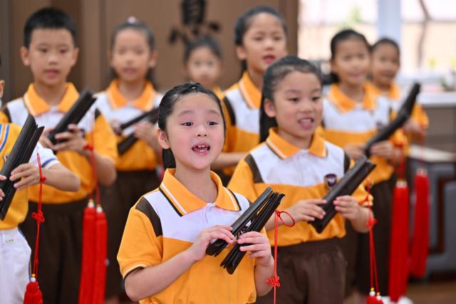 (251024) -- QUANZHOU, Oct. 24, 2025 (Xinhua) -- Students rehearse for a performance during a Nanyin class at a primary school in Jinjiang, southeast China's Fujian Province, on Oct. 23, 2025. Nanyin, which originated from southeast China's Fujian Province, is known as the "living fossil" of ancient Chinese music and literally means music in the south. It is a traditional opera in Fujian dialect.
In 2009, Nanyin was listed as a World Human Verbal and Intangible Cultural Heritage by UNESCO.
   The inheritance of Nanyin relies on dedicated practitioners. Cai Liyong, a Nanyin artist who started learning Nanyin since childhood, teaches Nanyin to students at a primary school in Jinjiang of Fujian Province every week, promoting authentic Nanyin among young students.
   In Singapore, a music society named Siong Leng is also dedicated to the preserving and promoting Nanyin. Established in 1941, Siong Leng made several successful performances in cities including Paris, Tokyo, and New York.
   From China to Singapore, from classrooms to the global stage, Nanyin weaves a continuous thread through cultural memories at home and abroad. (Xinhua/Jiang Kehong)