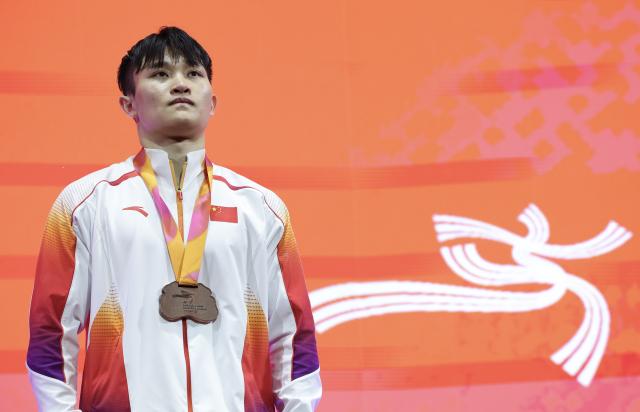 (251024) -- JAKARTA, Oct. 24, 2025 (Xinhua) -- Bronze medalist Lan Xingyu of China reacts during the awarding ceremony for the Men's Rings Final at 53rd FIG Artistic Gymnastics World Championships in Jakarta, Indonesia, on Oct. 24, 2025. (Xinhua/Bai Xuefei)