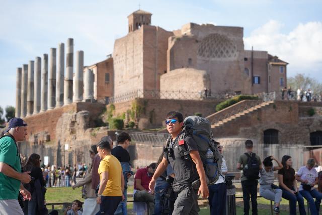 (251024) -- ROME, Oct. 24, 2025 (Xinhua) -- Chinese traveler on foot Cheng Long visits Palatine Hill in Rome, Italy, Oct. 19, 2025. TO GO WITH "Feature: From Xi'an to Rome on foot, one man's journey along the modern Silk Road" (Xinhua/Ren Yaoting)