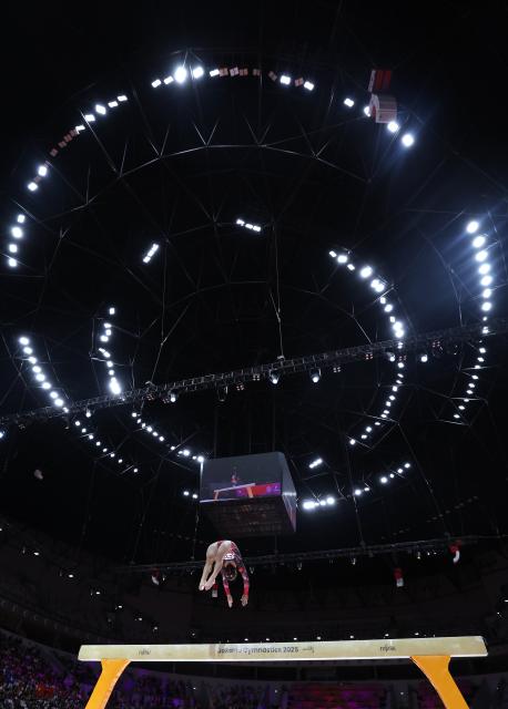 (251025) -- JAKARTA, Oct. 25, 2025 (Xinhua) -- Zhang Qingying of China competes during the women's balance beam final at 53rd FIG Artistic Gymnastics World Championships in Jakarta, Indonesia, on Oct. 25, 2025. (Xinhua/Bai Xuefei)