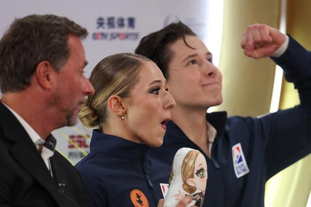 (251025) -- CHONGQING, Oct. 25, 2025 (Xinhua) -- Emilea Zingas (C)/Vadym Kolesnik (R) of the United States react after the ice dance free dance at the Cup of China ISU Grand Prix of Figure Skating 2025 in southwest China's Chongqing Municipality, Oct. 25, 2025. (Xinhua/Huang Wei)