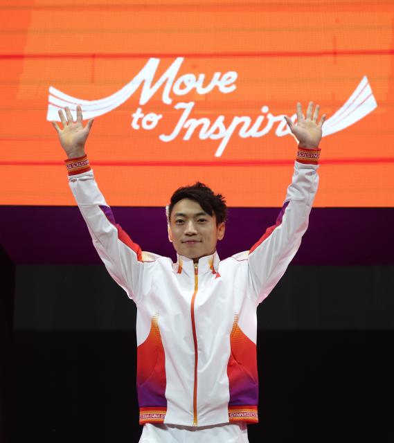 (251025) -- JAKARTA, Oct. 25, 2025 (Xinhua) -- Gold medalist Zou Jingyuan of China reacts during the awarding ceremony for the Men's Parallel Bars at 53rd FIG Artistic Gymnastics World Championships in Jakarta, Indonesia, on Oct. 25, 2025. (Xinhua/Bai Xuefei)