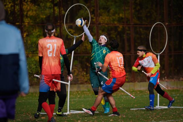 (251026) -- WARSAW, Oct. 26, 2025 (Xinhua) -- A player shoots the ball toward the hoop during the Polish qualifiers for the European Quadball Cup in Warsaw, Poland, Oct. 25, 2025. Quadball, originally inspired by Quidditch in the 'Harry Potter' series, combines elements of rugby, handball, water polo and dodgeball. (Photo by Jaap Arriens/Xinhua)