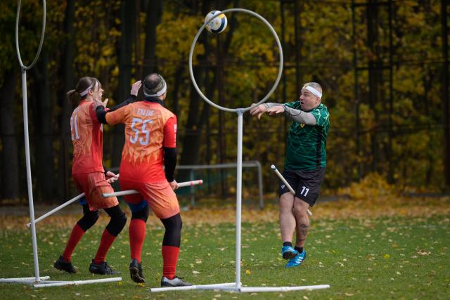 (251026) -- WARSAW, Oct. 26, 2025 (Xinhua) -- A player shoots the ball toward the hoop during the Polish qualifiers for the European Quadball Cup in Warsaw, Poland, Oct. 25, 2025. Quadball, originally inspired by Quidditch in the 'Harry Potter' series, combines elements of rugby, handball, water polo and dodgeball. (Photo by Jaap Arriens/Xinhua)