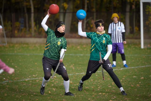 (251026) -- WARSAW, Oct. 26, 2025 (Xinhua) -- Two players throw balls during the Polish qualifiers for the European Quadball Cup in Warsaw, Poland, Oct. 25, 2025. Quadball, originally inspired by Quidditch in the 'Harry Potter' series, combines elements of rugby, handball, water polo and dodgeball. (Photo by Jaap Arriens/Xinhua)