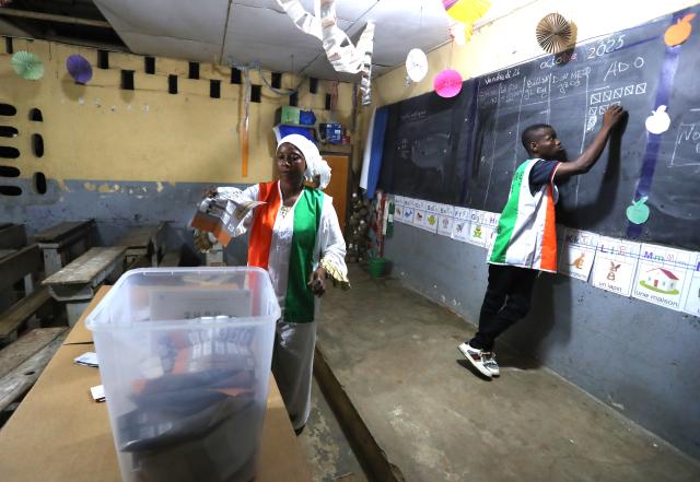 (251026) -- ABIDJAN, Oct. 26, 2025 (Xinhua) -- Staff members count ballots at a polling station in Abidjan, Cote d'Ivoire, Oct. 25, 2025. Polling stations for Cote d'Ivoire's presidential election closed at 6 p.m. local time on Saturday, marking the beginning of vote counting in Abidjan, local media reported. (Photo by Yvan Sonh/Xinhua)