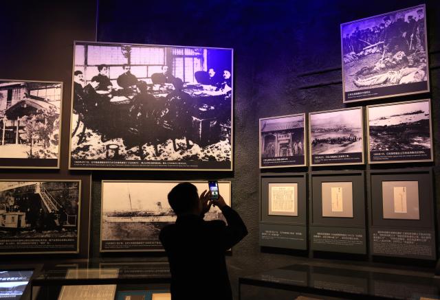 (251026) -- BEIJING, Oct. 26, 2025 (Xinhua) -- A man takes photos at "Unyielding Treasure Island: Loyal to the Motherland," an exhibition on the history of Taiwan compatriots' resistance against Japanese aggression, at the Museum of the War of Chinese People's Resistance Against Japanese Aggression in Beijing, capital of China, Oct. 25, 2025. Featuring 387 archive photographs and 453 cultural relics, the exhibition opened here on Saturday to commemorate the 80th anniversary of Taiwan's restoration to China. (Xinhua/Zhang Chenlin)