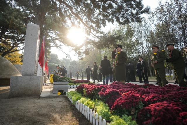 (251026) -- BEIJING, Oct. 26, 2025 (Xinhua) -- Chinese People's Volunteers (CPV) veterans present flowers to martyrs of the CPV at the CPV martyrs' cemetery in Shenyang, northeast China's Liaoning Province, Oct. 25, 2025. Liaoning Province on Saturday held flower baskets presenting ceremonies in Shenyang and Dandong to commemorate the 75th anniversary of the CPV's entering the Democratic People's Republic of Korea to fight in the War to Resist U.S. Aggression and Aid Korea. (Xinhua/Pan Yulong)