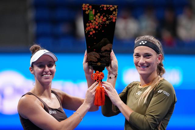 (251026) -- TOKYO, Oct. 26, 2025 (Xinhua) -- Timea Babos (R, Hungary) / Luisa Stefani (Brazil) celebrate during the awarding ceremony for the women's doubles final match between Timea Babos (Hungary) / Luisa Stefani (Brazil) and Anna Danilina (Kazakhstan) / Aleksandra Krunic (Serbia) at the Pan Pacific Open tennis tournament in Tokyo, Japan, on Oct. 26, 2025. (Xinhua/Jia Haocheng)