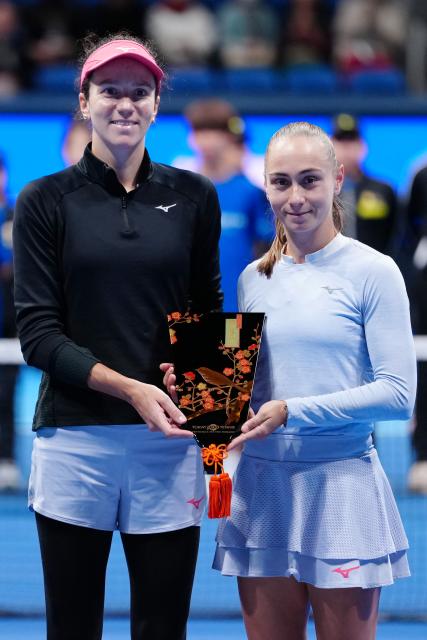 (251026) -- TOKYO, Oct. 26, 2025 (Xinhua) -- Anna Danilina (L, Kazakhstan) / Aleksandra Krunic (Serbia) react during the awarding ceremony after the women's doubles final match between Timea Babos (Hungary) / Luisa Stefani (Brazil) and Anna Danilina (Kazakhstan) / Aleksandra Krunic (Serbia) at the Pan Pacific Open tennis tournament in Tokyo, Japan, on Oct. 26, 2025. (Xinhua/Jia Haocheng)