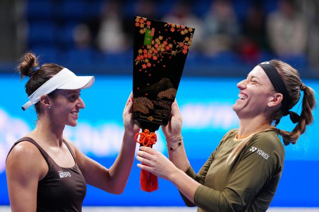 (251026) -- TOKYO, Oct. 26, 2025 (Xinhua) -- Timea Babos (R, Hungary) / Luisa Stefani (Brazil) celebrate during the awarding ceremony after the women's doubles final match between Timea Babos (Hungary) / Luisa Stefani (Brazil) and Anna Danilina (Kazakhstan) / Aleksandra Krunic (Serbia) at the Pan Pacific Open tennis tournament in Tokyo, Japan, on Oct. 26, 2025. (Xinhua/Jia Haocheng)
