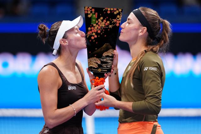 (251026) -- TOKYO, Oct. 26, 2025 (Xinhua) -- Timea Babos (R, Hungary) / Luisa Stefani (Brazil) celebrate during the awarding ceremony for the women's doubles final match between Timea Babos (Hungary) / Luisa Stefani (Brazil) and Anna Danilina (Kazakhstan) / Aleksandra Krunic (Serbia) at the Pan Pacific Open tennis tournament in Tokyo, Japan, on Oct. 26, 2025. (Xinhua/Jia Haocheng)