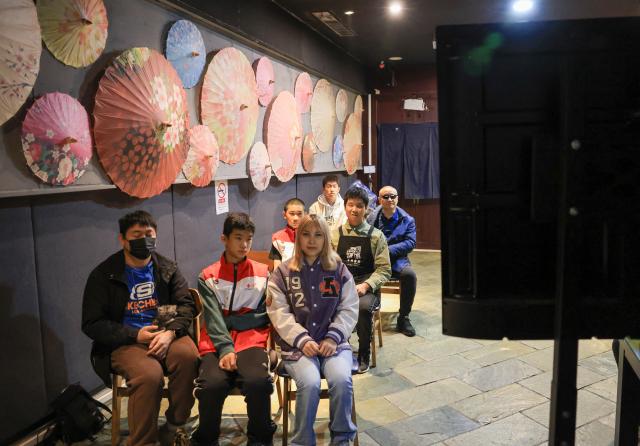 (251026) -- BEIJING, Oct. 26, 2025 (Xinhua) -- Visually impaired people and volunteers watch a movie with audio description at Trojan Fairy restaurant in Beijing, capital of China, Oct. 26, 2025. The Trojan Fairy restaurant, which focuses on supporting people with disabilities, hosted a film screening for 52 visually and physically impaired attendees. The event featured narrated audio descriptions to help visually impaired participants visualize scenes. (Xinhua/Yin Gang)
