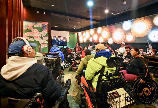 (251026) -- BEIJING, Oct. 26, 2025 (Xinhua) -- Physically impaired people communicate after a film screening at Trojan Fairy restaurant in Beijing, capital of China, Oct. 26, 2025. The Trojan Fairy restaurant, which focuses on supporting people with disabilities, hosted a film screening for 52 visually and physically impaired attendees. The event featured narrated audio descriptions to help visually impaired participants visualize scenes. (Xinhua/Yin Gang)