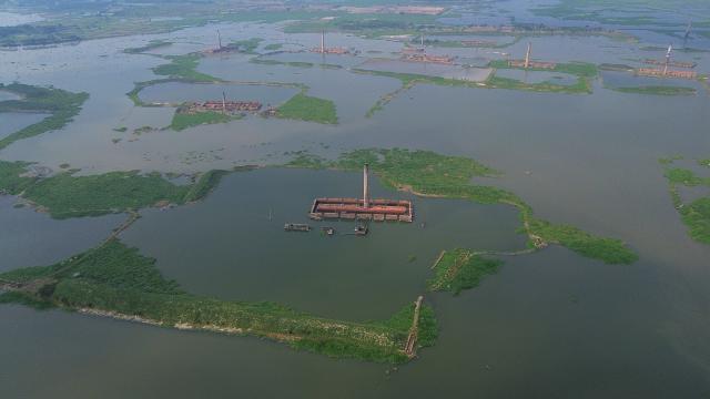 (251026) -- DHAKA, Oct. 26, 2025 (Xinhua) -- An aerial drone photo taken on Oct. 25, 2025 shows some brickyards half submerged in floodwater in Dhaka, Bangladesh. Heavy rainfall and rising river levels have submerged low-lying areas around the capital including some brickyards. (Photo by Habibur Rahman/Xinhua)