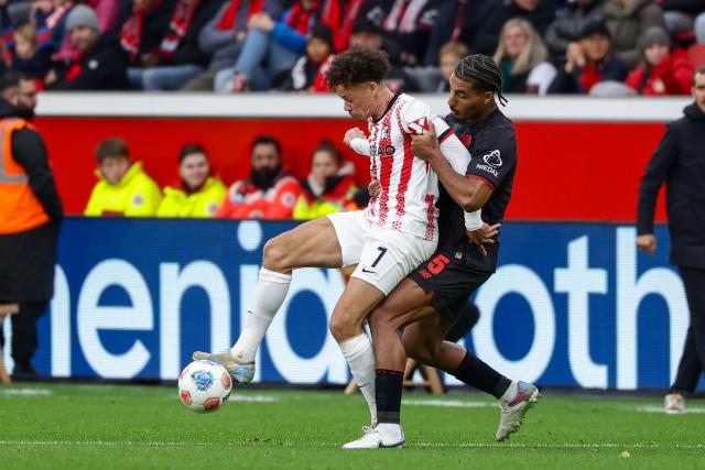 (251027) -- LEVERKUSEN, Oct. 27, 2025 (Xinhua) -- Loic Bade (R) of Bayer 04 Leverkusen vies with Derry Scherhant of SC Freiburg during the first division of Bundesliga football match between Bayer 04 Leverkusen and SC Freiburg in Leverkusen, Germany, Oct. 26. 2025. (Photo by Joachim Bywaletz/Xinhua)