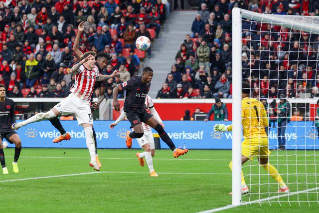(251027) -- LEVERKUSEN, Oct. 27, 2025 (Xinhua) -- Edmond Tapsoba (2nd R) of Bayer 04 Leverkusen heads for the ball during the first division of Bundesliga football match between Bayer 04 Leverkusen and SC Freiburg in Leverkusen, Germany, Oct. 26. 2025. (Photo by Joachim Bywaletz/Xinhua)