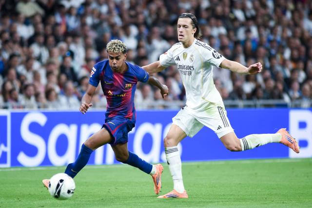 (251027) -- MADRID, Oct. 27, 2025 (Xinhua) -- Alvaro Carreras (R) of Real Madrid vies with Lamine Yamal of Barcelona during the La Liga football match between Real Madrid and FC Barcelona at Santiago Bernabeu Stadium in Madrid, Spain, on Oct. 26, 2025. (Photo by Gustavo Valiente/Xinhua)