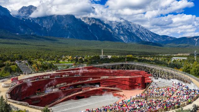 (251027) -- BEIJING, Oct. 27, 2025 (Xinhua) -- An aerial drone photo taken on Oct. 26, 2025 shows tourists watching a performance at the Yulong Snow Mountain scenic spot in Lijiang City, southwest China's Yunnan Province. (Xinhua/Hu Chao)