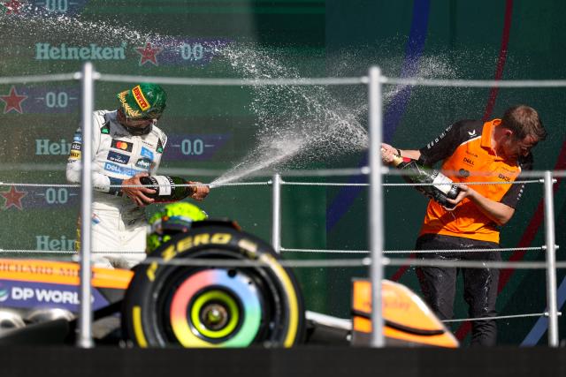 (251027) -- MEXICO CITY, Oct. 27, 2025 (Xinhua) -- First-placed McLaren's British driver Lando Norris (L) celebrates during the awarding ceremony for the Formula One Mexico Grand Prix at the Hermanos Rodriguez Circuit in Mexico City, Mexico, Oct. 26, 2025. (Photo by Song Haiyuan/Xinhua)