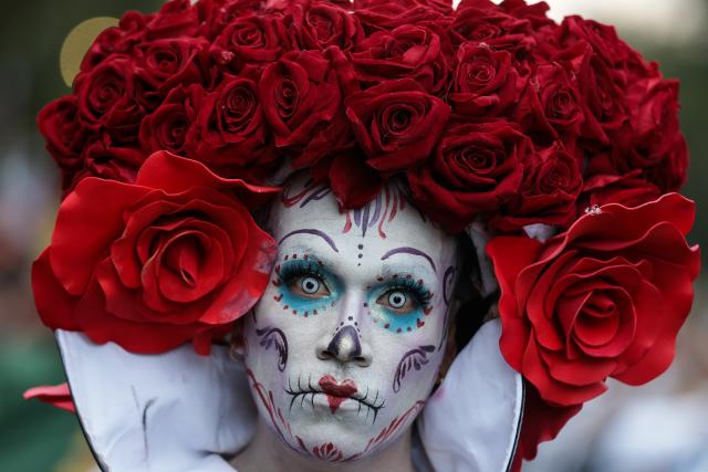 (251027) -- MEXICO CITY, Oct. 27, 2025 (Xinhua) -- A participant with facial makeup takes part in the Catrinas Parade in Mexico City, capital of Mexico, on Oct. 26, 2025. The Catrinas Parade was held on Sunday ahead of the Day of the Dead. (Photo by Francisco Canedo/Xinhua)