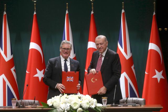 (251027) -- ANKARA, Oct. 27, 2025 (Xinhua) -- Turkish President Recep Tayyip Erdogan (R) and British Prime Minister Keir Starmer display the signed agreement in Ankara, Türkiye, Oct. 27, 2025. Türkiye signed a deal on Monday to buy 20 Eurofighter Typhoon fighter jets from Britain for 8 billion pounds (10.64 billion U.S. dollars), as Ankara seeks to bolster its defense capabilities amid a turbulent regional landscape. (Mustafa Kaya/Handout via Xinhua)