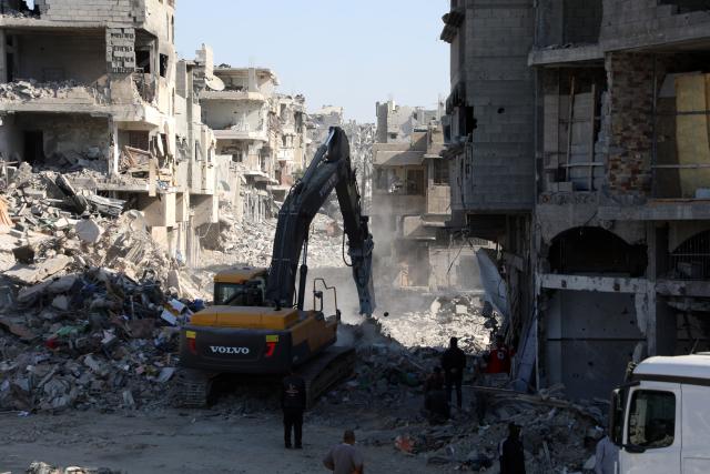 (251027) -- GAZA, Oct. 27, 2025 (Xinhua) -- An Egyptian Excavator works at al-Tuffah area east of Gaza City, Oct. 27, 2025. Red Cross and Egyptian teams have been allowed to enter the Gaza Strip to search for the bodies of hostages, Israeli government spokesperson Shosh Bedrosian said on Sunday. (Photo by Rizek Abdeljawad/Xinhua)