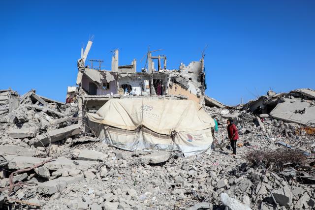 (251027) -- GAZA, Oct. 27, 2025 (Xinhua) -- A palestinian is seen at a street with destroyed buildings, in Jabalia refugee camp northern Gaza Strip, Oct. 27, 2025. The United Nations estimates that approximately 92 percent of all residential buildings in Gaza -- around 436,000 homes -- have been damaged or destroyed since the start of the conflict. (Photo by Rizek Abdeljawad/Xinhua)