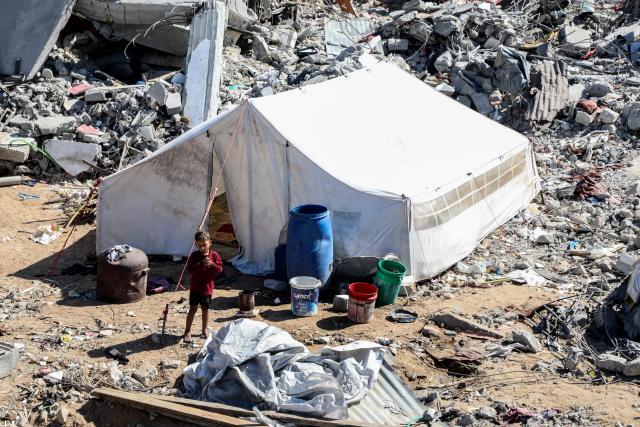 (251027) -- GAZA, Oct. 27, 2025 (Xinhua) -- A palestinian is seen at a street with destroyed buildings, in Jabalia refugee camp northern Gaza Strip, Oct. 27, 2025. The United Nations estimates that approximately 92 percent of all residential buildings in Gaza -- around 436,000 homes -- have been damaged or destroyed since the start of the conflict. (Photo by Rizek Abdeljawad/Xinhua)