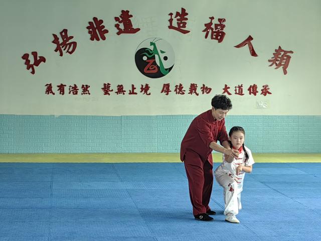 (251028) -- JINAN, Oct. 28, 2025 (Xinhua) -- Liu Xin (L) instructs her apprentice to practice Mantis Boxing at a martial arts school in Laiyang City, east China's Shandong Province, Oct. 14, 2025. TO GO WITH "Feature: Female inheritor in east China promotes martial arts, strength, serenity" (Xinhua/Shao Kun)