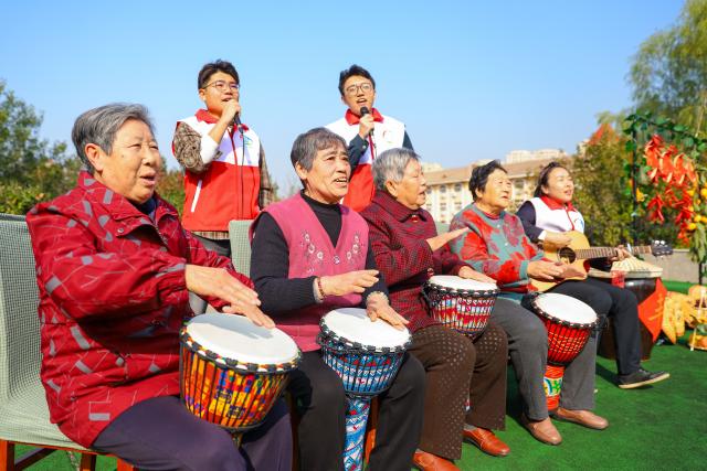(251028) -- BEIJING, Oct. 28, 2025 (Xinhua) -- Volunteers perform together with elderly people at a welfare house in Qingdao, east China's Shandong Province, Oct. 28, 2025. A series of activities were held across the country to mark China's Chongyang Festival, which will fall on Oct. 29 this year. Also known as Seniors' Day in China nowadays, it highlights the public's care for elderly people. (Photo by Zhang Ying/Xinhua)