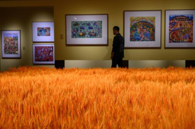 (251028) -- BEIJING, Oct. 28, 2025 (Xinhua) -- A man visits the "Colorful Brushstrokes upon the Earth: the 2025 Chinese Farmers' Paintings Exhibition" at the National Museum of China in Beijing, capital of China, Oct. 28, 2025. The exhibition opened here on Tuesday. (Xinhua/Jin Liangkuai)