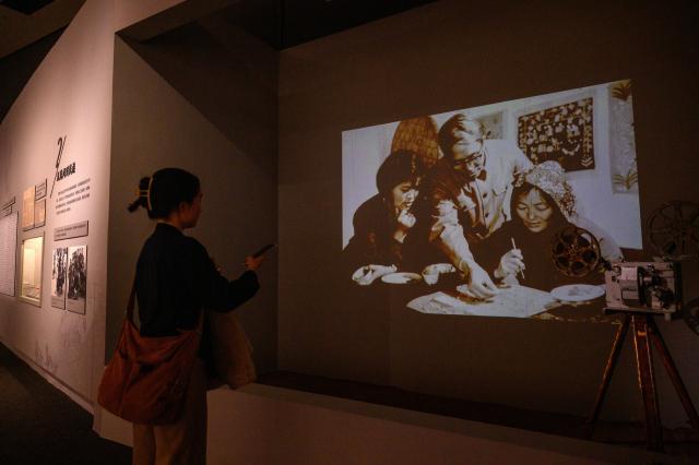 (251028) -- BEIJING, Oct. 28, 2025 (Xinhua) -- A woman visits the "Colorful Brushstrokes upon the Earth: the 2025 Chinese Farmers' Paintings Exhibition" at the National Museum of China in Beijing, capital of China, Oct. 28, 2025. The exhibition opened here on Tuesday. (Xinhua/Jin Liangkuai)