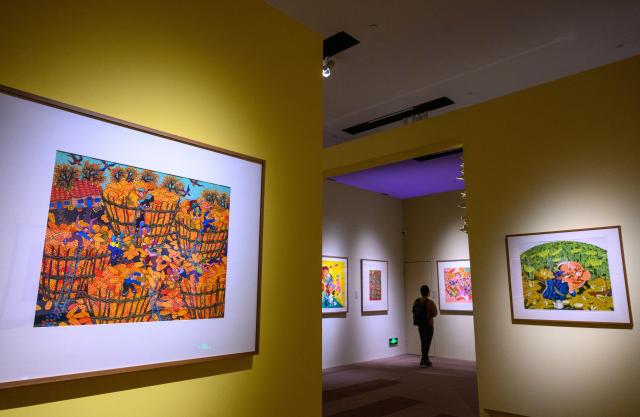 (251028) -- BEIJING, Oct. 28, 2025 (Xinhua) -- A man visits the "Colorful Brushstrokes upon the Earth: the 2025 Chinese Farmers' Paintings Exhibition" at the National Museum of China in Beijing, capital of China, Oct. 28, 2025. The exhibition opened here on Tuesday. (Xinhua/Jin Liangkuai)