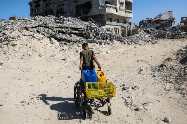 (251028) -- GAZA, Oct. 28, 2025 (Xinhua) -- A Palestinian fetches water in the Shati refugee camp, west of Gaza City, Oct. 28, 2025. Palestinians may have to wait hours for a small amount of water, which is largely unavailable due to damage to water networks caused by Israeli bombing during the war. (Photo by Rizek Abdeljawad/Xinhua)
