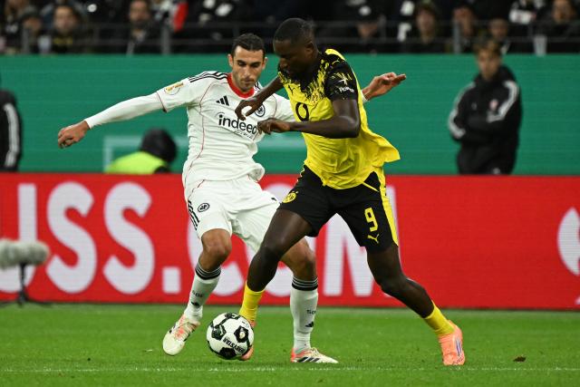 (251029) -- FRANKFURT, Oct. 29, 2025 (Xinhua) -- Ellyes Skhiri (L) of Eintracht Frankfurt vies with Serhou Guirassy of Borussia Dortmund during the German Cup football second round match between Eintracht Frankfurt and Borussia Dortmund in Frankfurt, Germany, Oct. 28, 2025. (Photo by Ulrich Hufnagel/Xinhua)