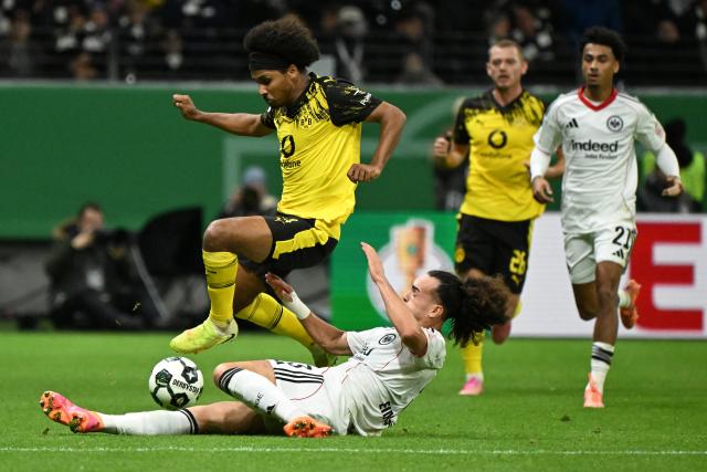 (251029) -- FRANKFURT, Oct. 29, 2025 (Xinhua) -- Arthur Theate (bottom, front) of Eintracht Frankfurt vies with Karim Adeyemi (up, front) of Borussia Dortmund during the German Cup football second round match between Eintracht Frankfurt and Borussia Dortmund in Frankfurt, Germany, Oct. 28, 2025. (Photo by Ulrich Hufnagel/Xinhua)