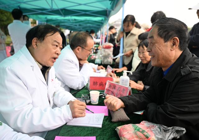 (251029) -- BEIJING, Oct. 29, 2025 (Xinhua) -- Doctors offer free medical consultations to senior citizens during an event celebrating Chongyang Festival in Xiping County, central China's Henan Province, Oct. 29, 2025. A series of celebration activities were held across the country to mark Chongyang Festival, which falls on Oct. 29 this year. Also known as China's Seniors' Day, it honors the country's traditional virtues of filial piety and family love. (Xinhua/Li Jianan)