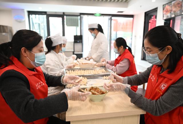 (251029) -- BEIJING, Oct. 29, 2025 (Xinhua) -- Volunteers make dumplings at a community canteen for local elderly people in Xiping County, central China's Henan Province, Oct. 29, 2025. A series of celebration activities were held across the country to mark Chongyang Festival, which falls on Oct. 29 this year. Also known as China's Seniors' Day, it honors the country's traditional virtues of filial piety and family love. (Xinhua/Li Jianan)