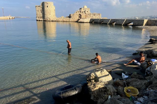 (251029) -- SIDON, Oct. 29, 2025 (Xinhua) -- People fish near the Saida Naval Castle in Sidon, southern Lebanon, Oct. 29, 2025. (Photo by Ali Hashisho/Xinhua)