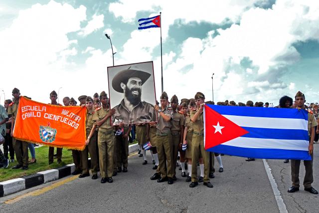 (251029) -- HAVANA, Oct. 29, 2025 (Xinhua) -- Military school cadets hold a portrait of commander Camilo Cienfuegos during a ceremony commemorating Camilo Cienfuegos in Havana, capital of Cuba, on Oct. 28, 2025. Cubans gathered at seaside to offer flowers to commemorate Camilo Cienfuegos on Tuesday. Cuba marked the 66th anniversary of the death of Camilo Cienfuegos. Camilo, along with Fidel Castro and Che Guevara, are the three chief commanders of the Cuban revolution. He died in a flight accident at the age of 27. (Photo by Xinhua/Joaquin Hernandez)