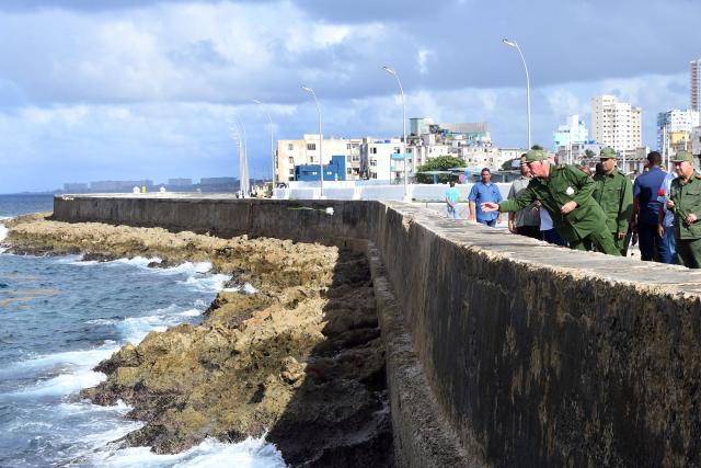 (251029) -- HAVANA, Oct. 29, 2025 (Xinhua) -- Cuban president Miguel Diaz-Canel throws a flower into the sea during a ceremony commemorating Camilo Cienfuegos in Havana, capital of Cuba, on Oct. 28, 2025. Cubans gathered at seaside to offer flowers to commemorate Camilo Cienfuegos on Tuesday. Cuba marked the 66th anniversary of the death of Camilo Cienfuegos. Camilo, along with Fidel Castro and Che Guevara, are the three chief commanders of the Cuban revolution. He died in a flight accident at the age of 27. (Photo by Xinhua/Joaquin Hernandez)