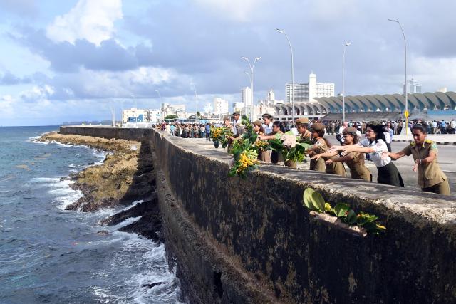 (251029) -- HAVANA, Oct. 29, 2025 (Xinhua) -- Military school cadets throw flowers into the sea during a ceremony commemorating Camilo Cienfuegos in Havana, capital of Cuba, on Oct. 28, 2025. Cubans gathered at seaside to offer flowers to commemorate Camilo Cienfuegos on Tuesday. Cuba marked the 66th anniversary of the death of Camilo Cienfuegos. Camilo, along with Fidel Castro and Che Guevara, are the three chief commanders of the Cuban revolution. He died in a flight accident at the age of 27. (Photo by Xinhua/Joaquin Hernandez)