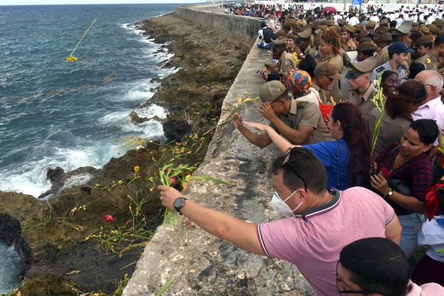 (251029) -- HAVANA, Oct. 29, 2025 (Xinhua) -- People throw flowers into the sea during a ceremony commemorating Camilo Cienfuegos in Havana, capital of Cuba, on Oct. 28, 2025. Cubans gathered at seaside to offer flowers to commemorate Camilo Cienfuegos on Tuesday. Cuba marked the 66th anniversary of the death of Camilo Cienfuegos. Camilo, along with Fidel Castro and Che Guevara, are the three chief commanders of the Cuban revolution. He died in a flight accident at the age of 27. (Photo by Xinhua/Joaquin Hernandez)